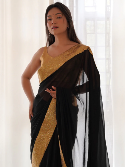 Women's black designer georgette festive saree with golden sequinned lace border and matching blouse