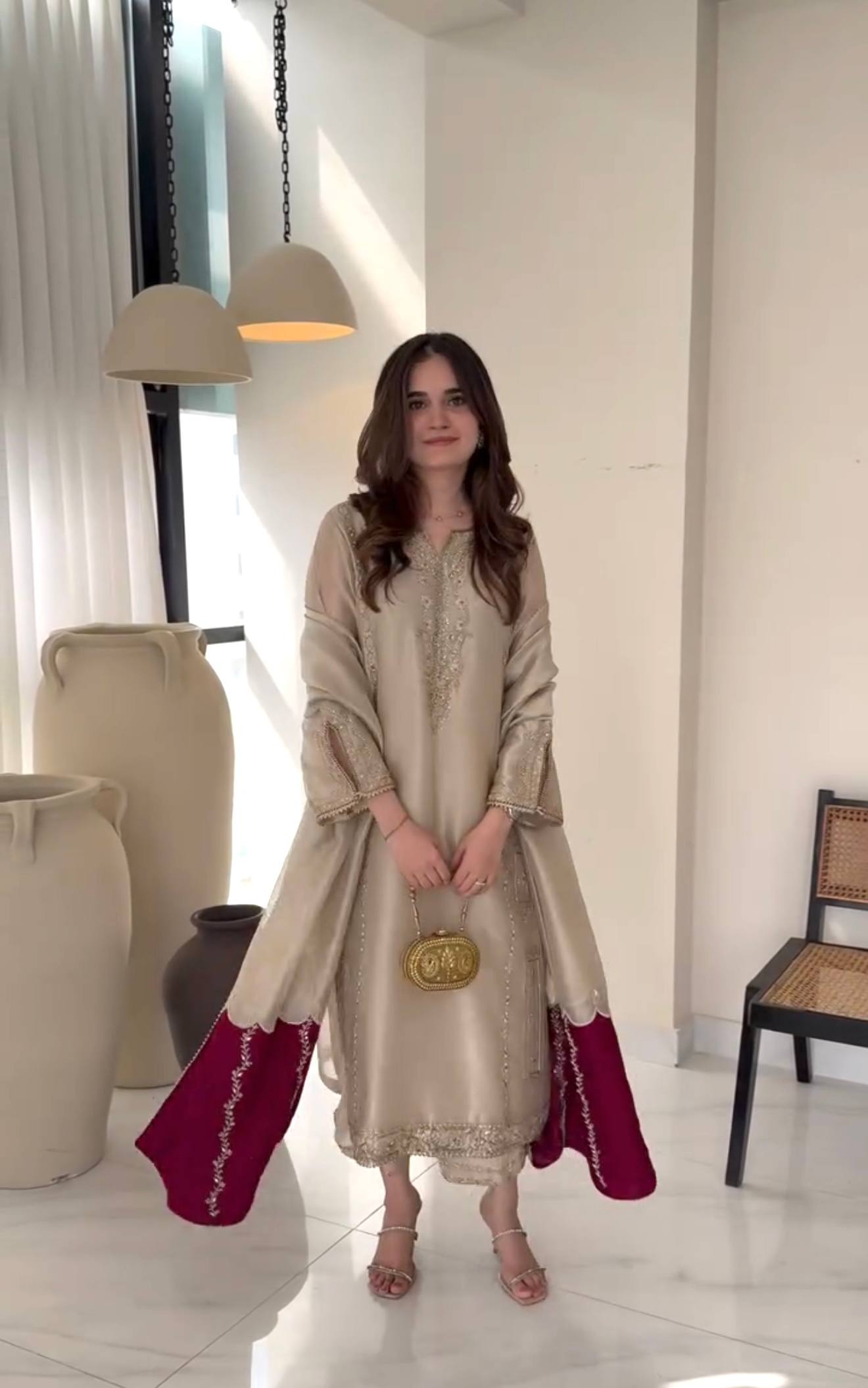 Beige Gmy silk embroidered suit styled with maroon dupatta and potli bag
