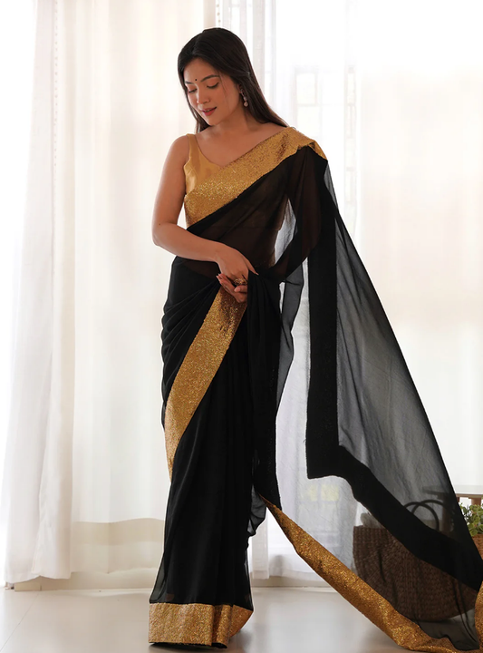 Elegant black georgette saree paired with golden full sequence work blouse