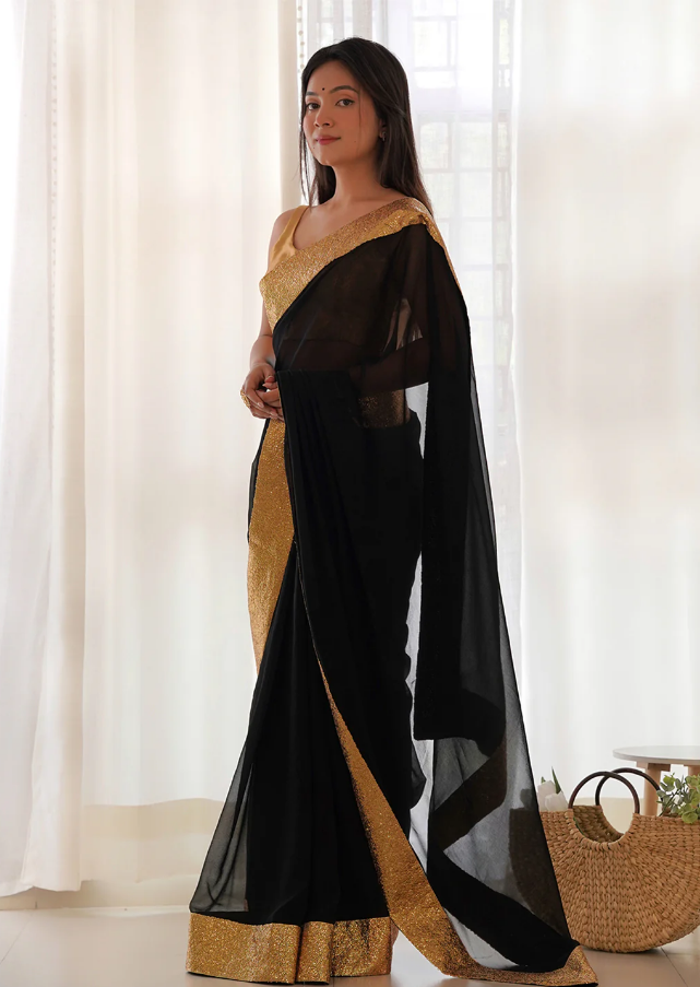 Designer black georgette party wear saree with golden sequinned embroidery border

