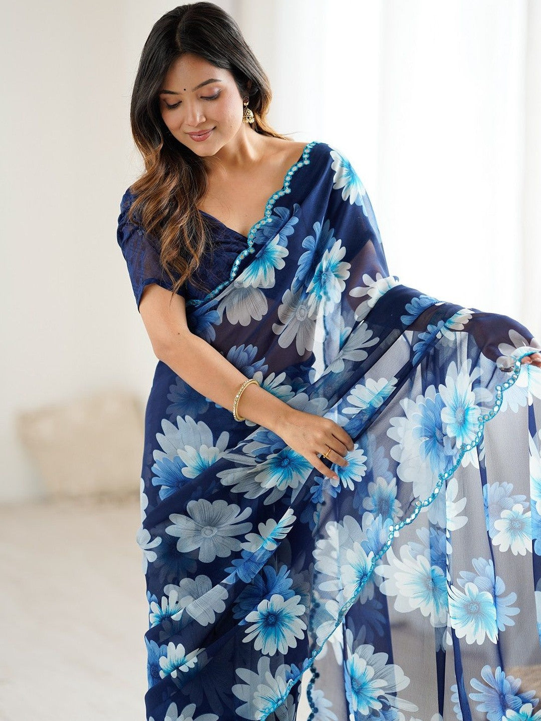 Designer blue georgette silk saree with floral print and mirror work lace border