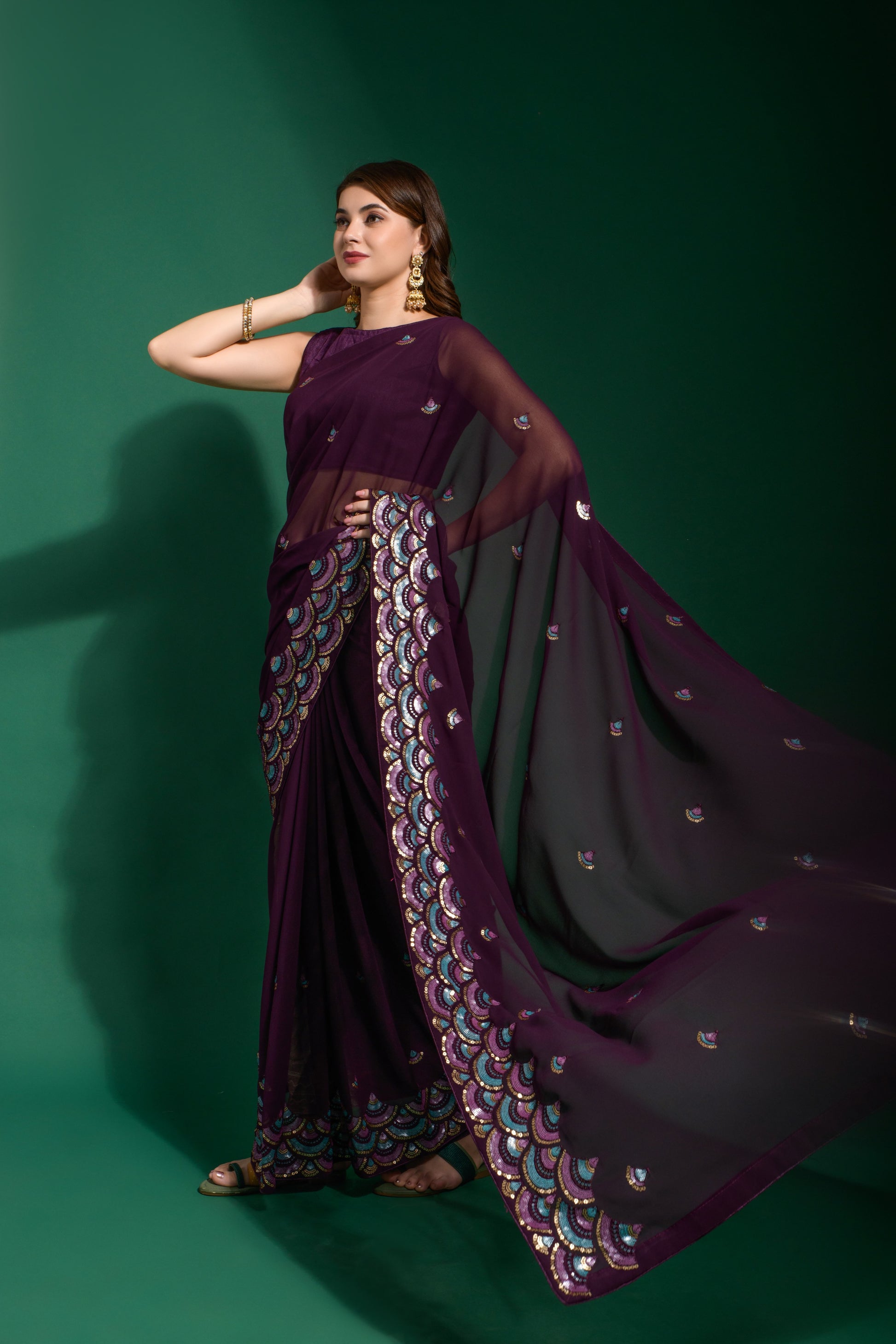 Designer purple heavy georgette party wear saree with embroidered sequin border and plain blouse.