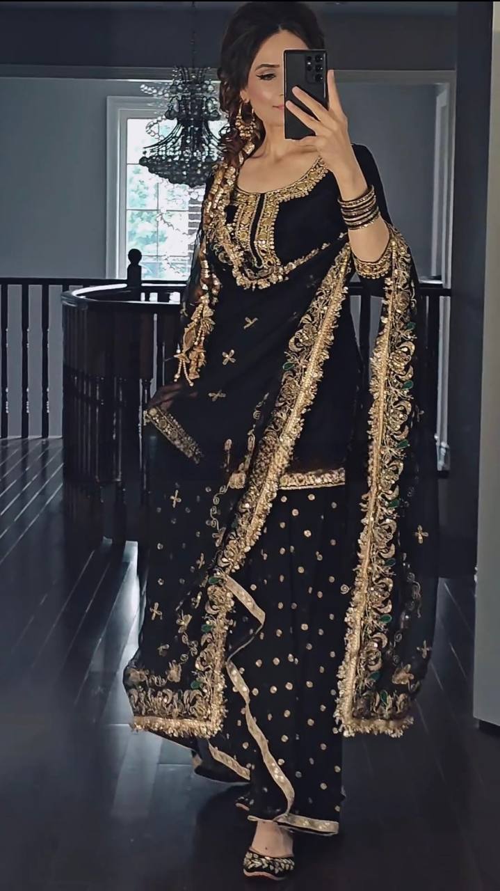 Close-up of mirror and sequence embroidery work on dhoti suit top