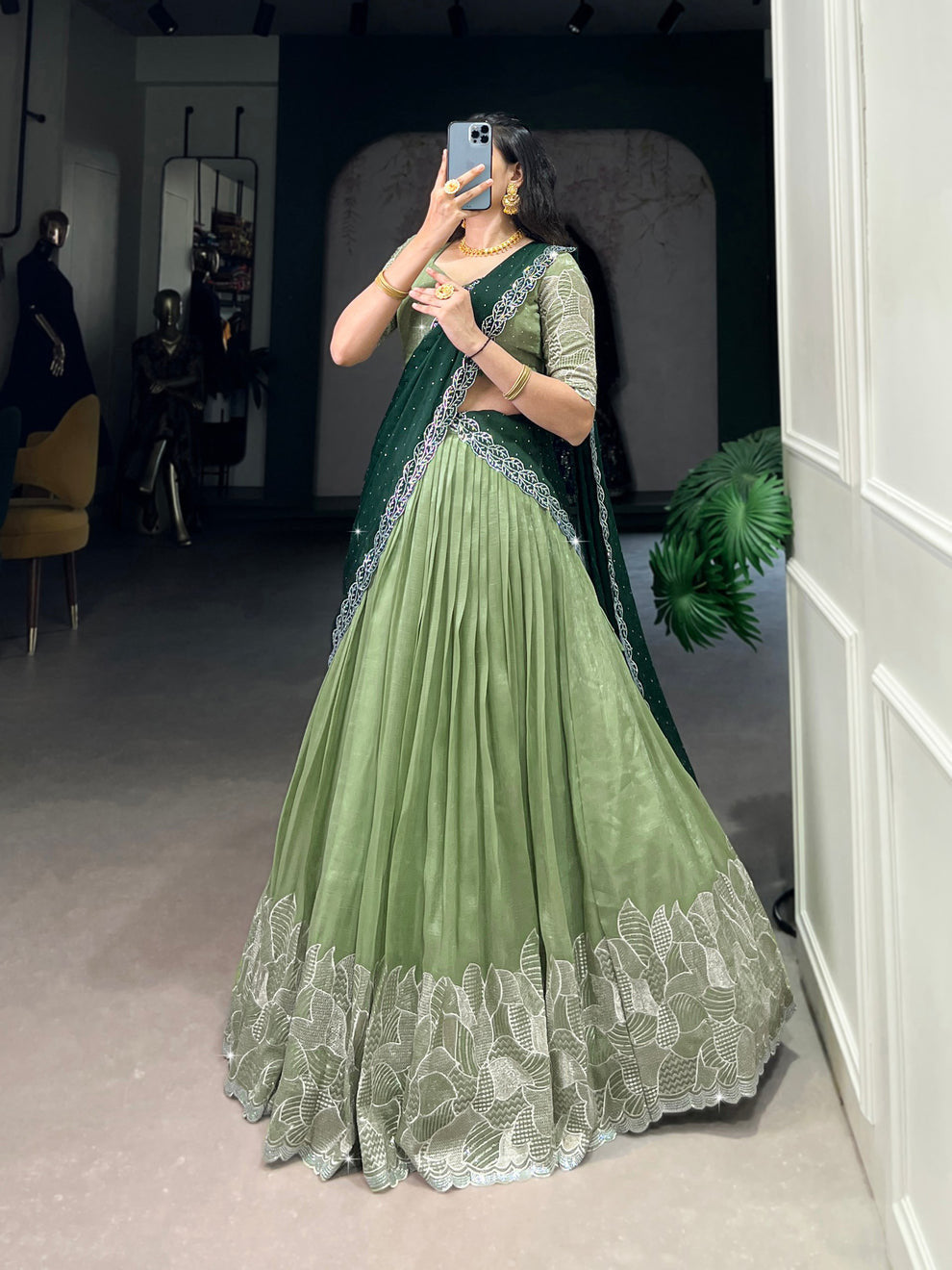 Traditional green embroidered lehenga with matching blouse and stylish saree-style dupatta for festive wear.