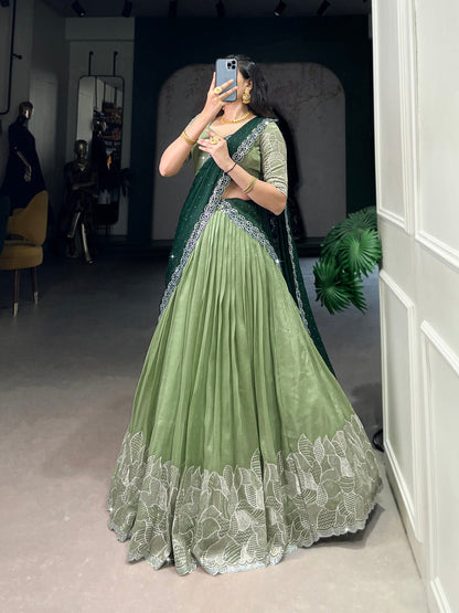 Traditional green embroidered lehenga with matching blouse and stylish saree-style dupatta for festive wear.