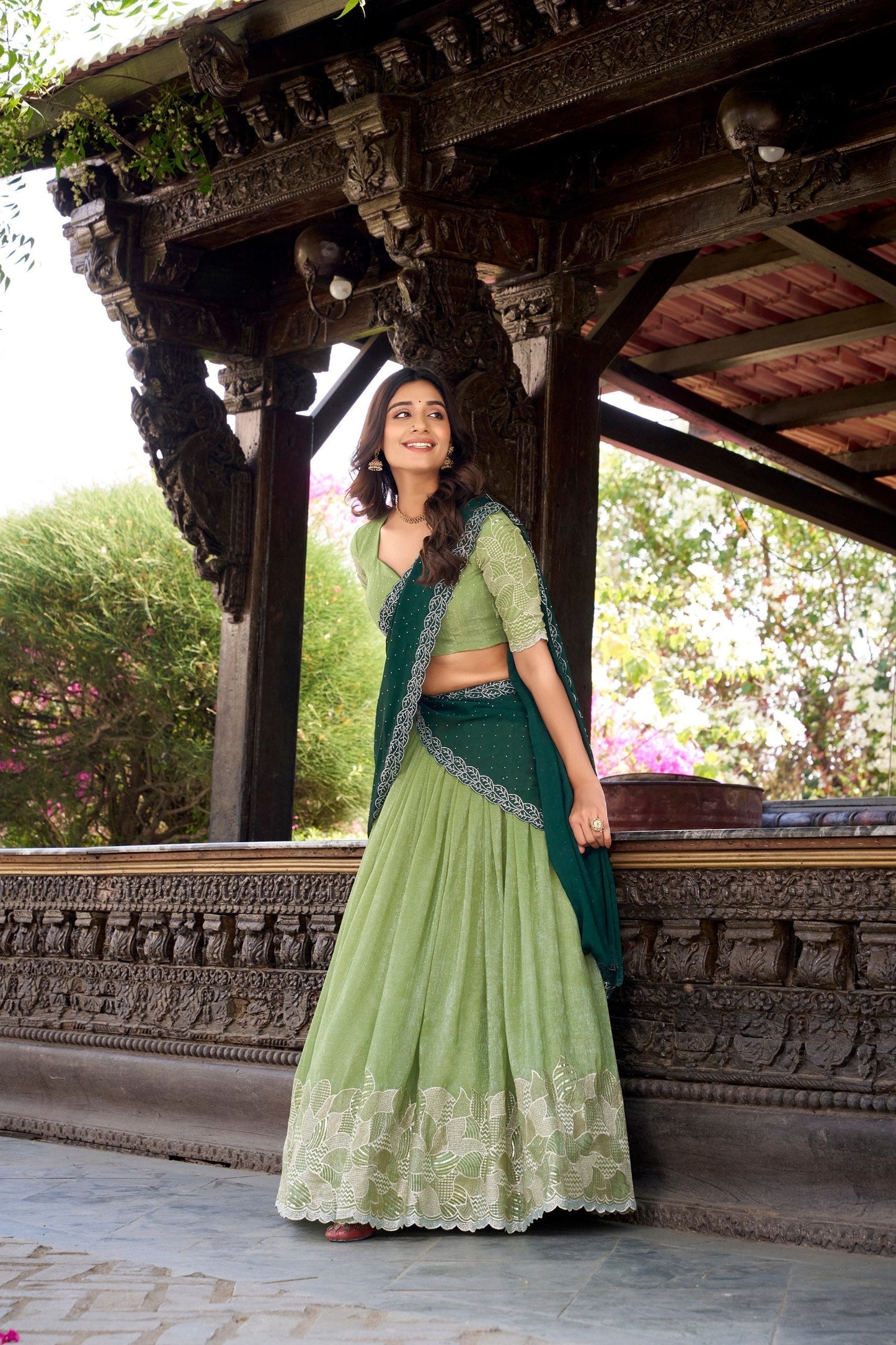 Elegant parrot green lehenga featuring heavy embroidered floral border and matching blouse