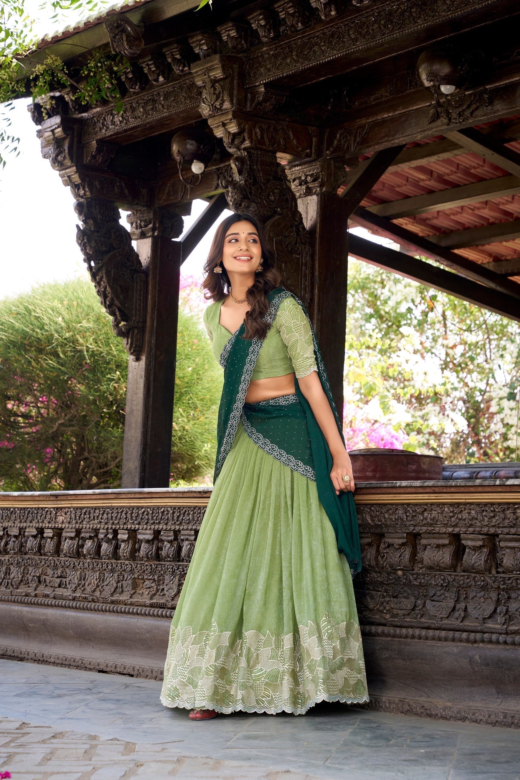 Elegant parrot green lehenga featuring heavy embroidered floral border and matching blouse
