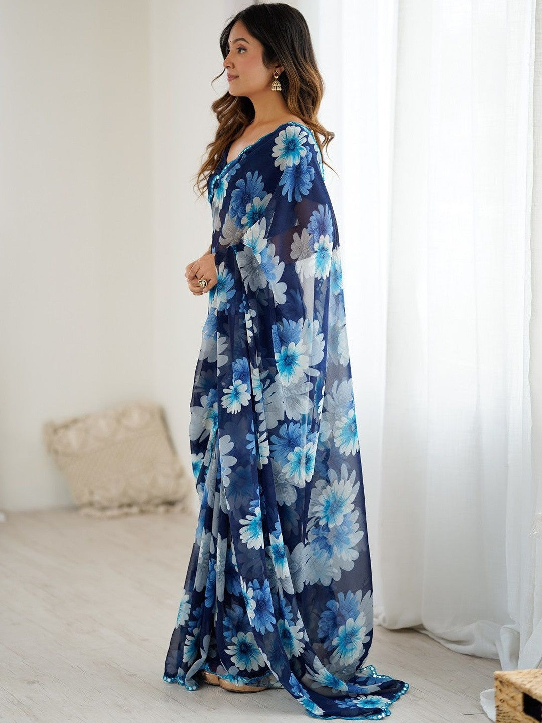 Premium blue georgette silk saree featuring multicolor floral print and mirror work border