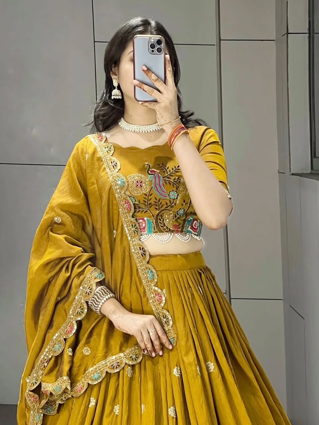 Premium mustard wedding lehenga featuring colorful ethnic embroidery and lace border