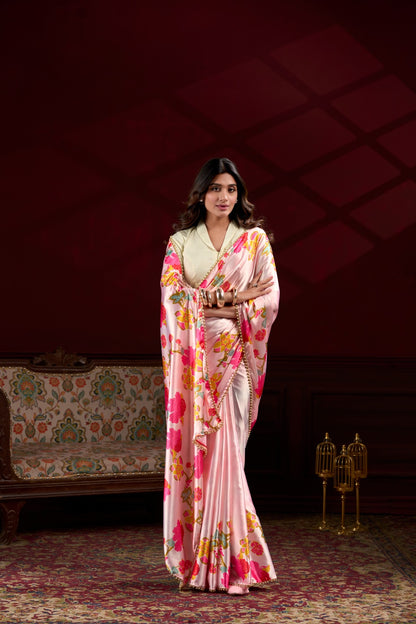 Premium peach Japan Satin Silk saree featuring all-over floral print and stylish pearl lace border.