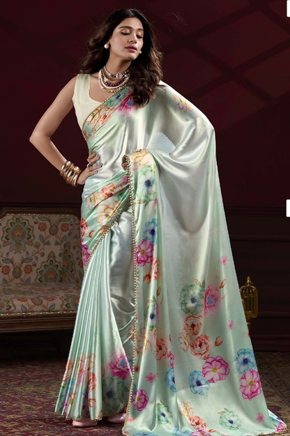 Premium sea green Japan Satin Silk saree featuring all-over floral print and stylish pearl lace border.