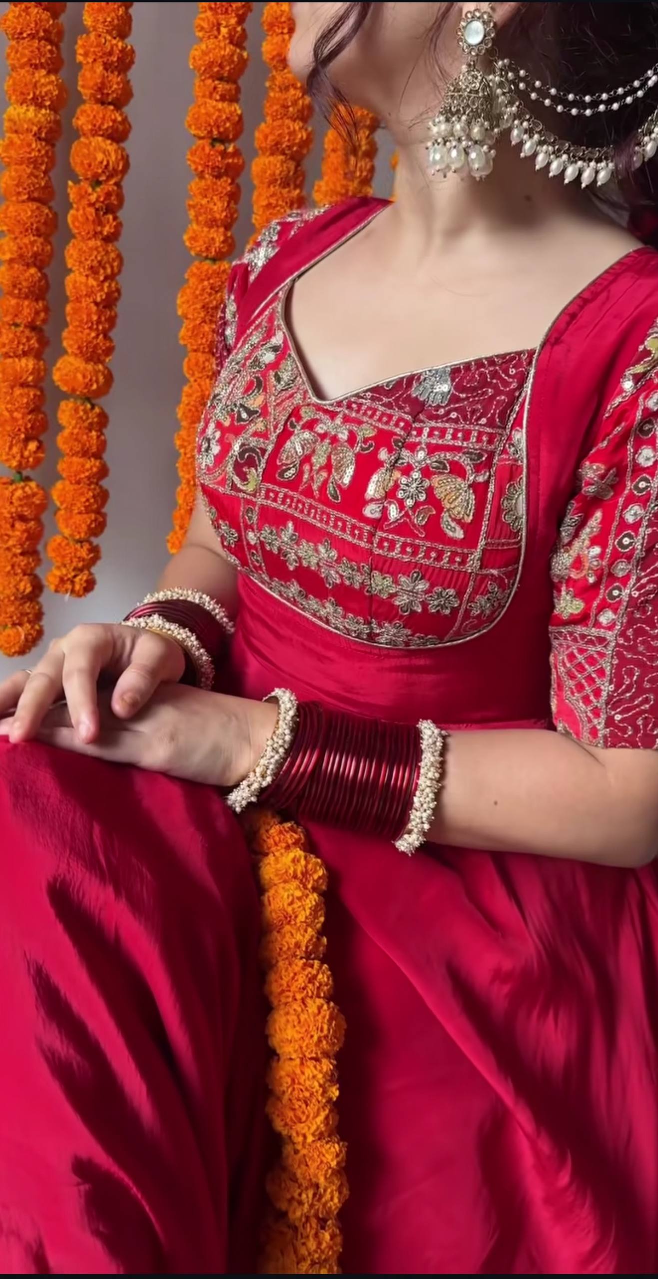 Red Anarkali gown side view showing flair and embroidery detail
