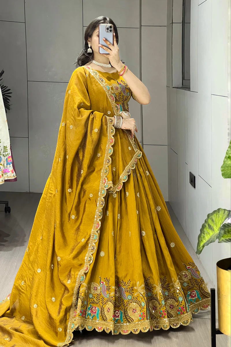 Traditional mustard lehenga choli with intricate peacock and elephant motifs for festive occasions