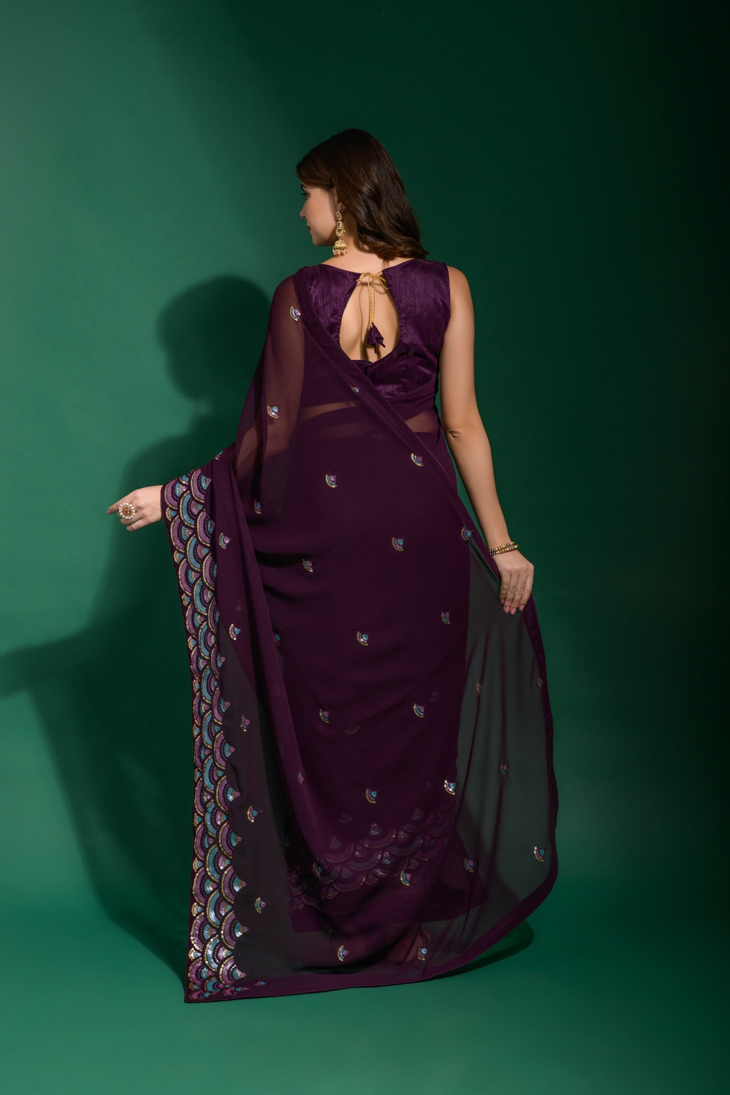 Elegant wedding wear purple georgette saree featuring multi colour sequin embroidery and premium border.