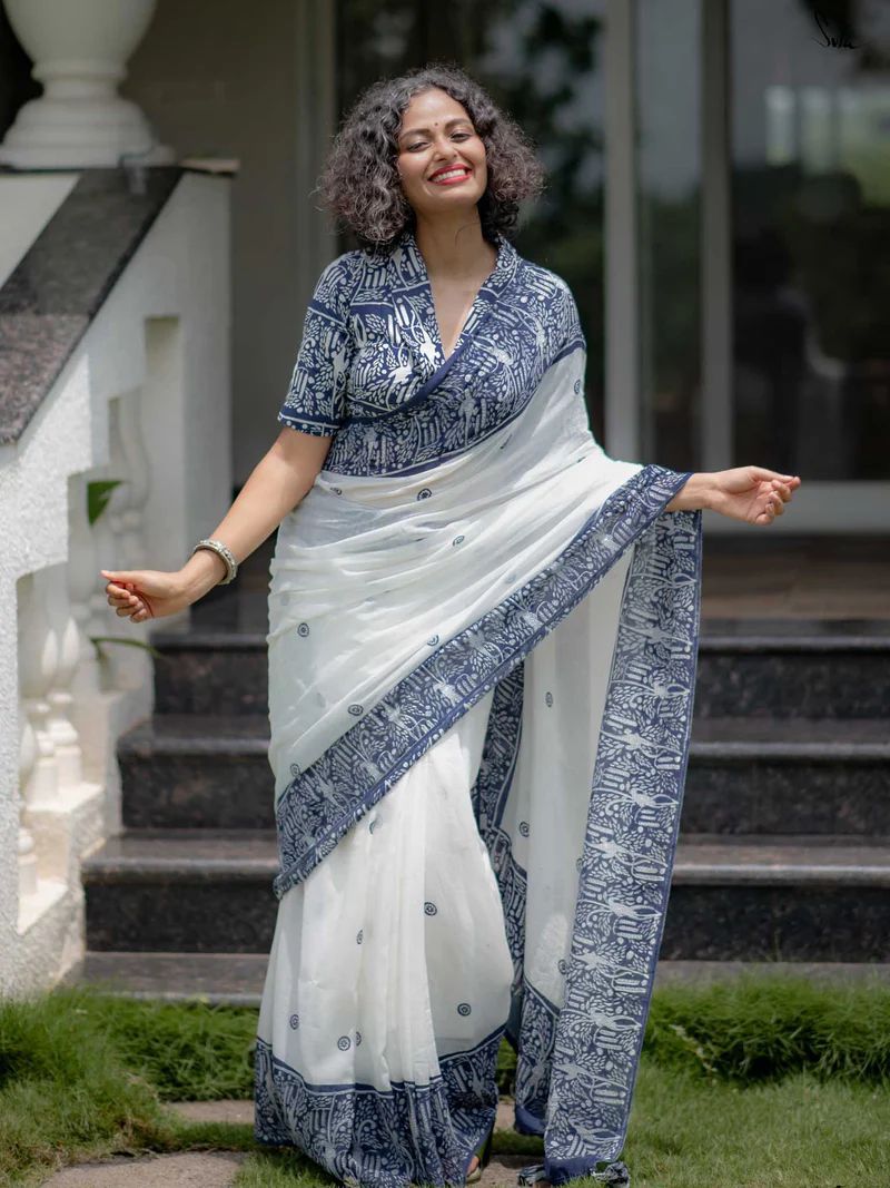 Woman wearing premium white and blue soft silk printed saree with elegant border design